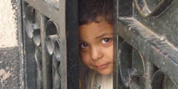 Libyan boy behind a door