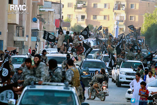 Islamic State fighters parade in Raqqa, Syria