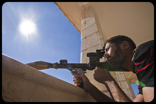 ALEPPO COUNTRYSIDE, SYRIA, 23 July, 2013: A rebel of the Free Syrian Army prepares to shoot a rpg into the Shia village of Nobbul &#8211; © Dona_Bozzi / Shutterstock.com