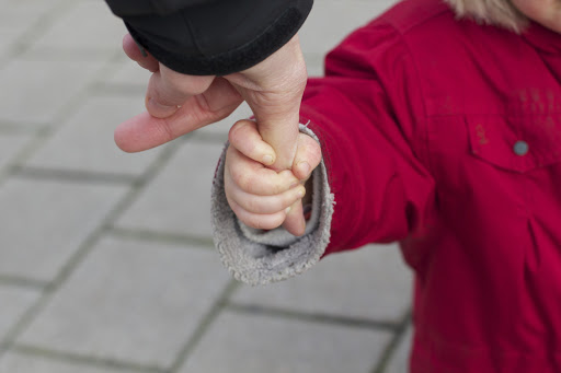 Child grabbing parent&#8217;s finger