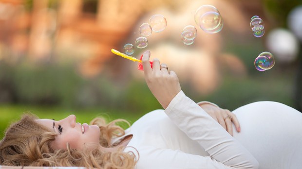 HERO-PREGNANT-BUBBLES-WOMAN-LAYING-Shutterstock