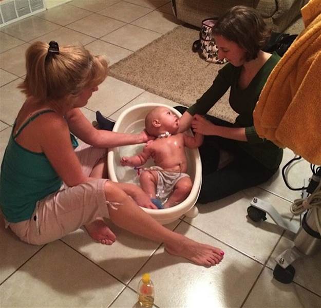 Cori Salchert, and Salchert's daughter, Johanna, 22, helps her bathe Charlie.