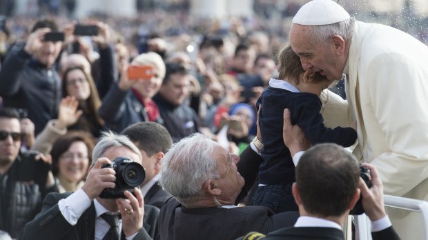 Pope Francis kissing a Child
