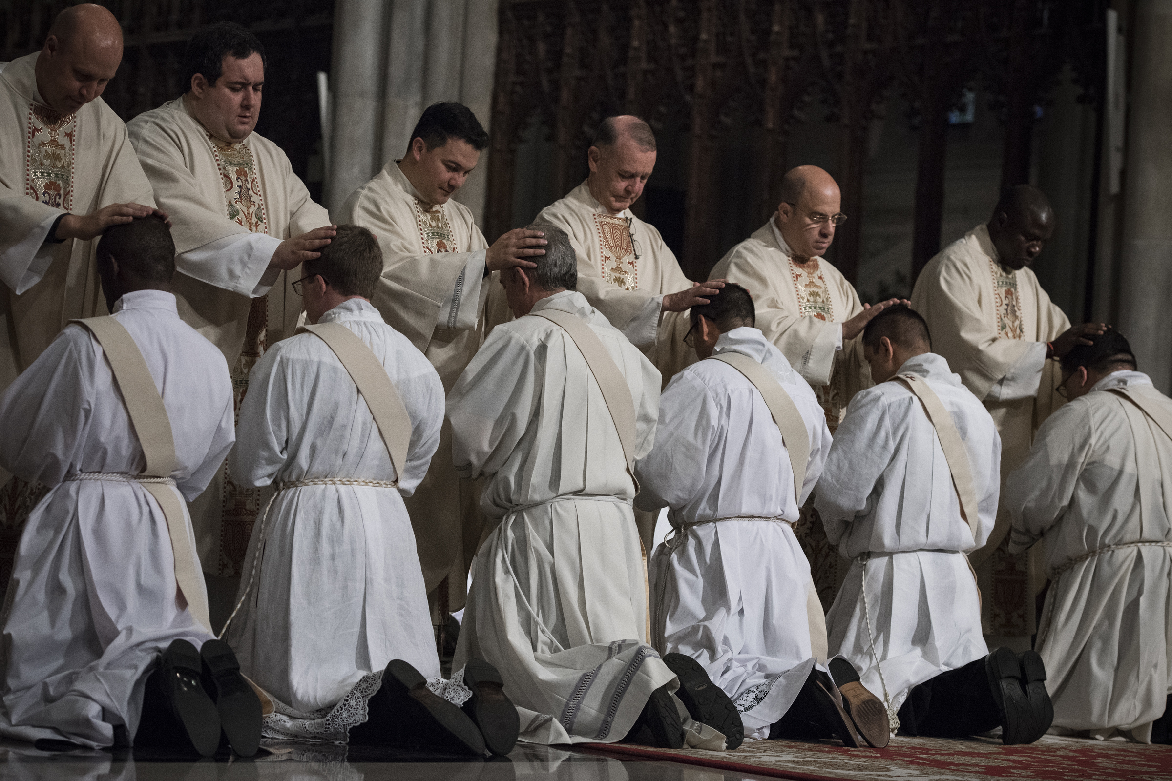 The Laying On of Hands: By this ritual the ordaining bishop and the other priests invoke the Holy Spirit to come down upon the one to be ordained, giving him a sacred character and setting him apart for the designated ministry. (USCCB)
