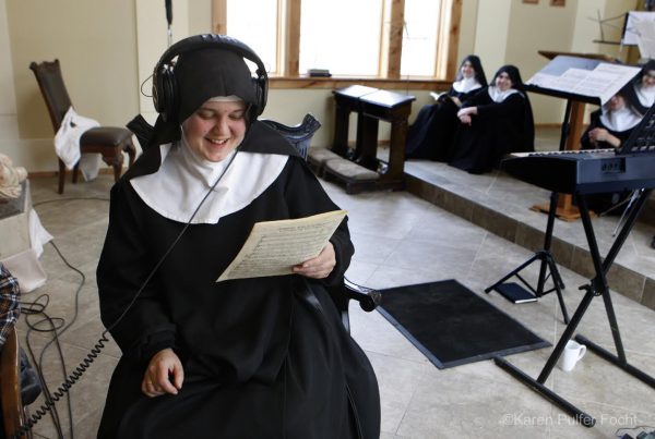 Mother Cecilia, Prioress, listens to a playback while sisters look on. Image by Karen Pulfer Focht, with permission