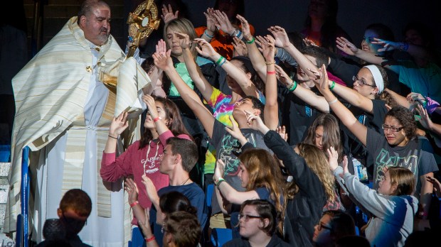 WEB-EUCHARIST-PASSION-YOUTH-REACHING-George-Martell&#8211;Archdiocese-of-Boston-BCDS-CC