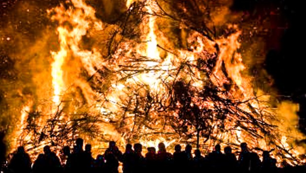 HUGE BONFIRE,PEOPLE SURROUNDING