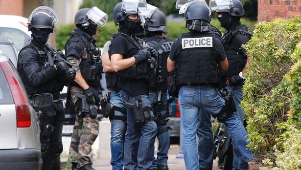 French-policemen-stand-outside-a-house-during-a-search-in-a-house