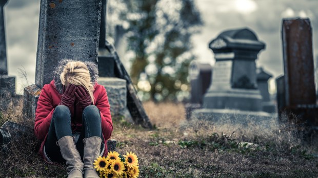 web-death-woman-crying-cemetary-benoit-daoust-shutterstock_328914971