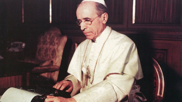 Pope Pius XII writes one of his wartime Christmas radio messages using a typewriter at the Vatican in this undated photo.