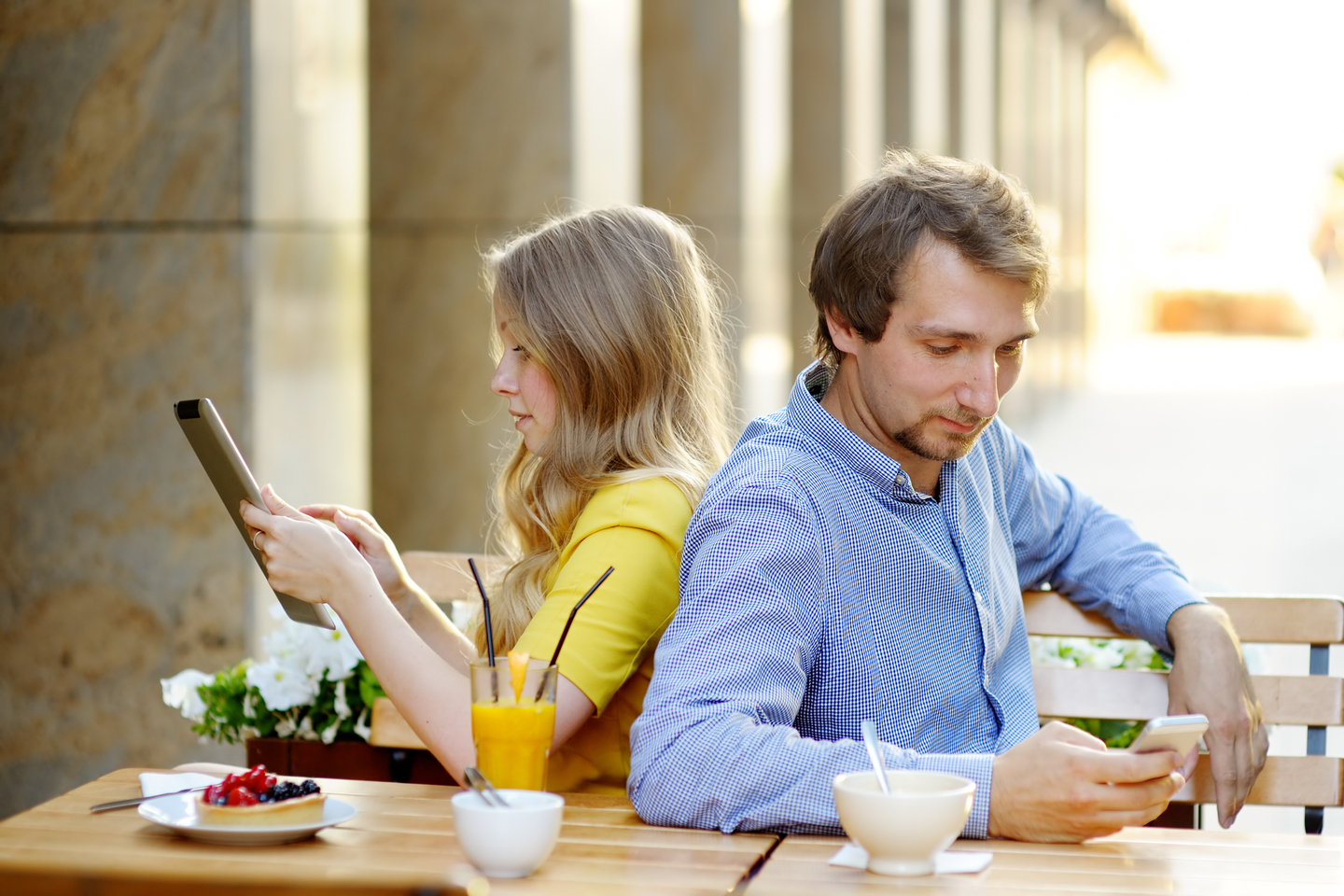 Preview Save to a lightbox Find Similar Images Share Stock Photo: Young couple using smart phone and tablet pc in the outdoor cafe