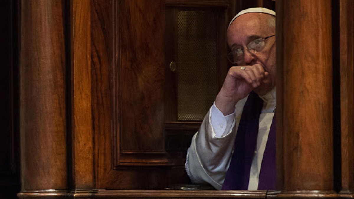 Pope Francis sitting in a confession booth – AFP – fr