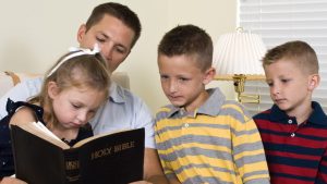 WEB FATHER KIDS HOLY BIBLE © JHDT PRODUCTIONS Shutterstock