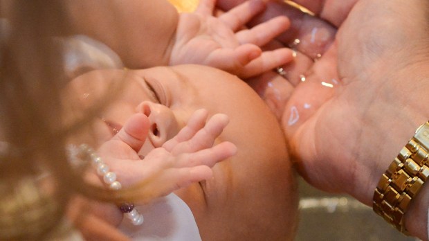 WEB3-BAPTISM-INFANT-WATER-HAND-CLOSEUP-Jeffrey-Bruno
