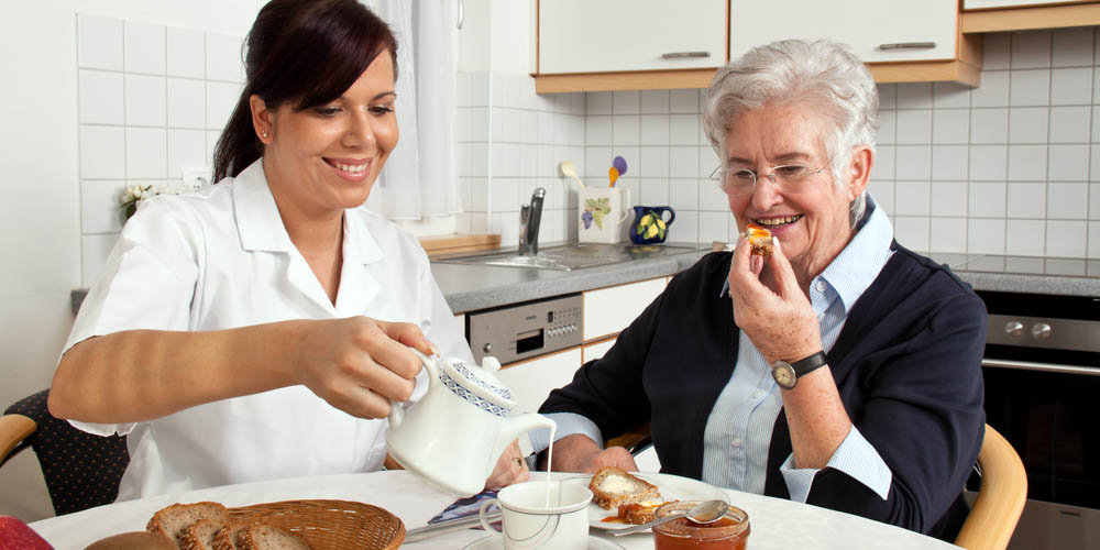 WEB3-geriatric nurse helps elderly woman at breakfast-shutterstock_89251555-Lisa S.-AI