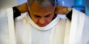 Why do priests wear white albs?