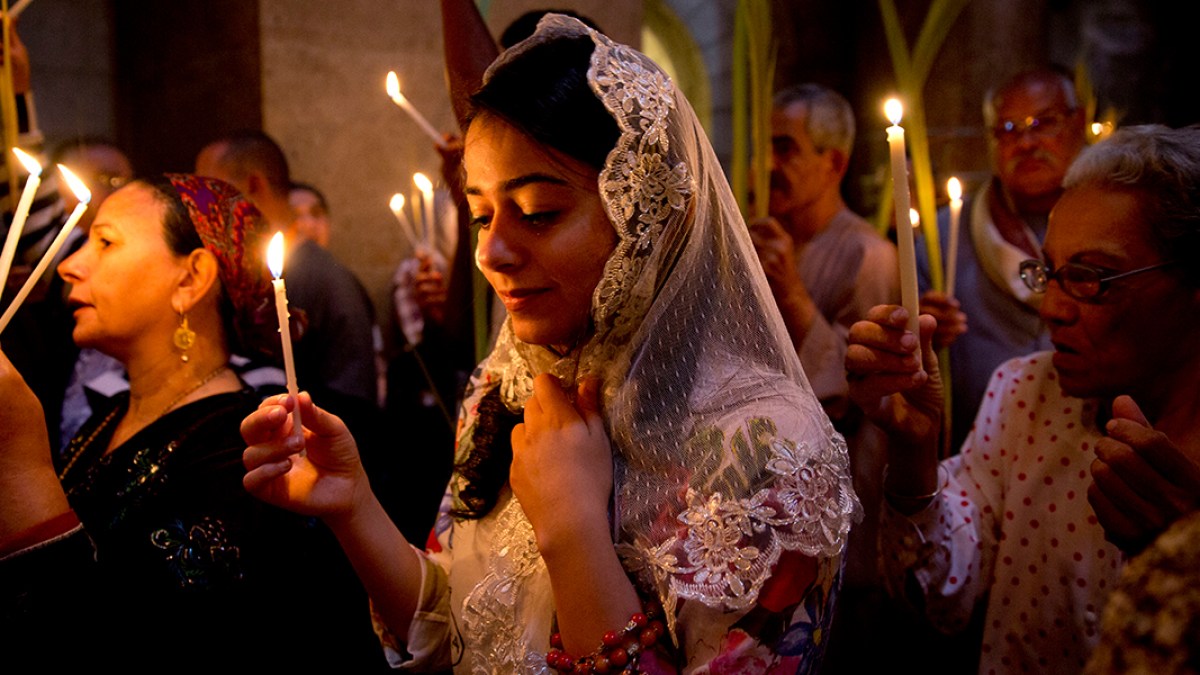 WEB3-YOUNG-WOMAN-JERUSALEM-CANDLE-EASTER-AP_16115341941895-AP-Photo-Ariel-Schalit