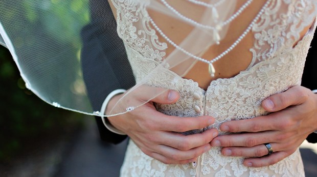 WEB3 BRIDE AND GROOM HANDS BACK OF DRESS WEDDING Leah Kelley CC