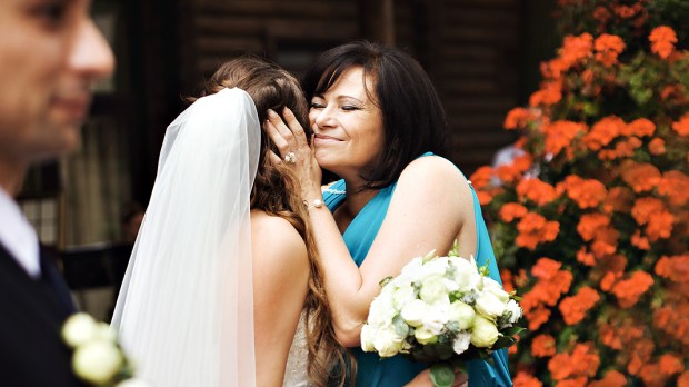 BRIDE HUGGING MOTHER