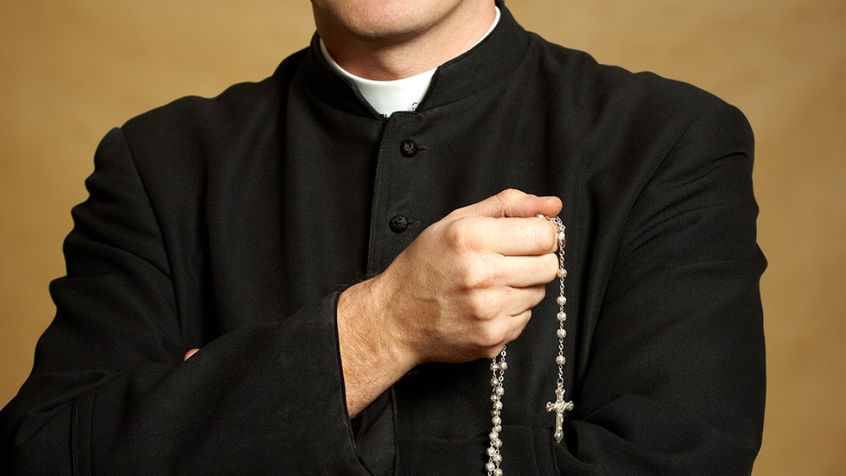 web3-catholic-priest-rosary-cassock-monika-wisniewska-shutterstock