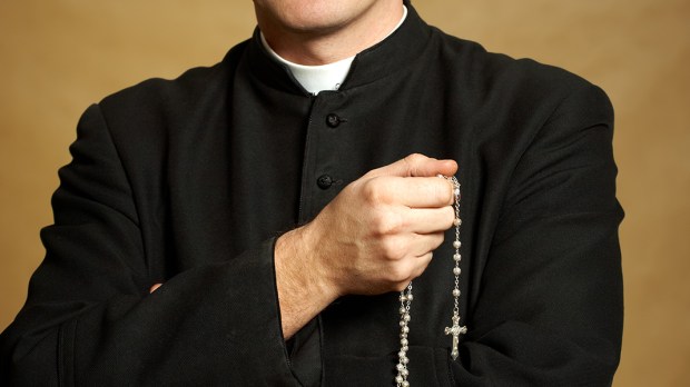 web3-catholic-priest-rosary-cassock-monika-wisniewska-shutterstock