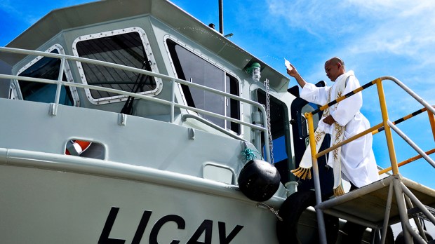 PRIEST BLESSES BOAT