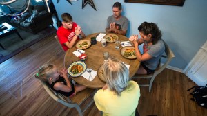 FAMILY PRAYS BEFORE DINNER