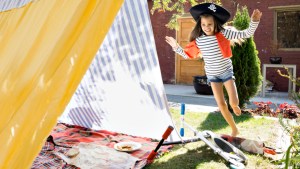 GIRL PLAYING IN BACKYARD