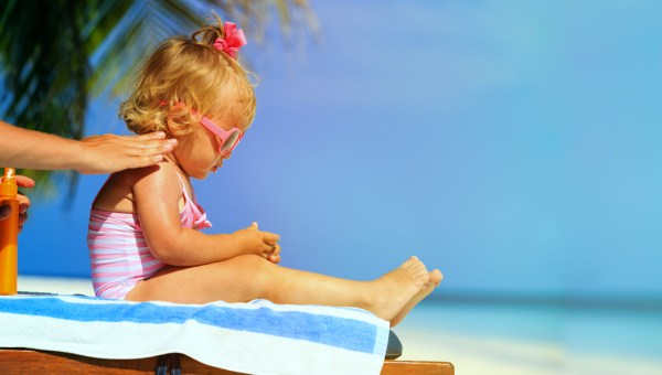 MOM APPLYING SUNSCREEN TO DAUGHTER