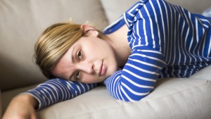 WOMAN LAYING ON COUCH