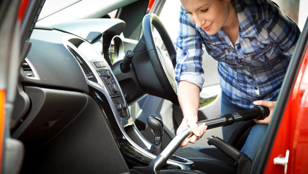 WOMAN,VACUMMING,INTERIOR OF CAR