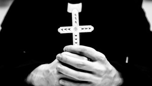 PRIEST HOLDING CROSS