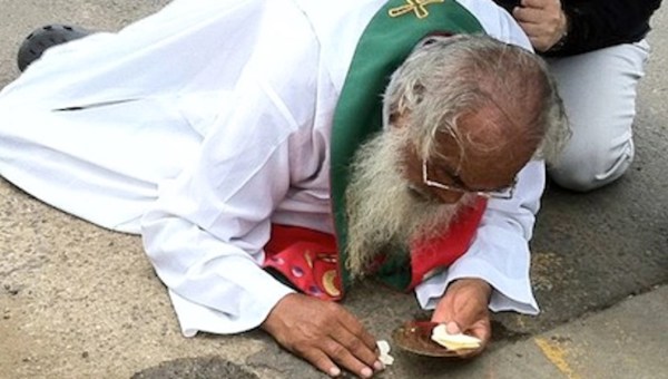 MAN ON GROUND WITH EUCHARIST