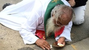 MAN ON GROUND WITH EUCHARIST