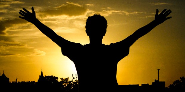 MAN STANDING,ARMS OUT