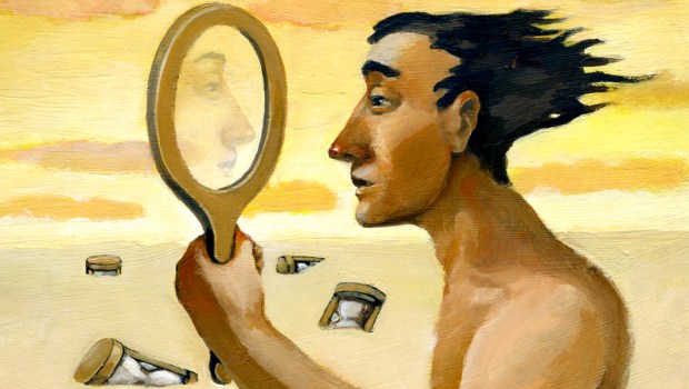 MAN LOOKING INTO MIRROR