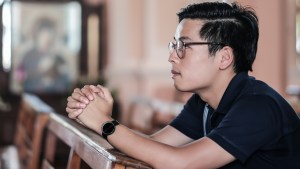 MAN PRAYING IN CHURCH