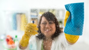 WOMAN CLEANING GLASS