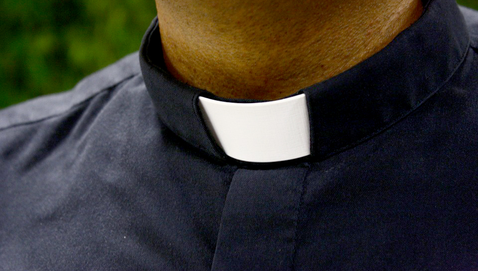 Catholic Gay Priest Praying With Rainbow Collar Stock Photo