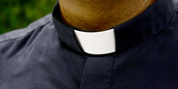 Why do priests wear a white collar?