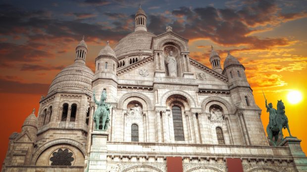 Sun_sets_behind_Sacred_Heart_Basilica_Paris_shutterstock_388475575