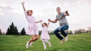 Family Jumping in Field