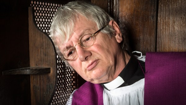 PRIEST IN CONFESSIONAL