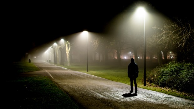 MAN STANDING IN THE DARK