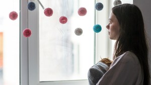 Woman Looking Out Window