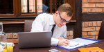 MAN WORKING AT DESK