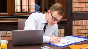 MAN WORKING AT DESK