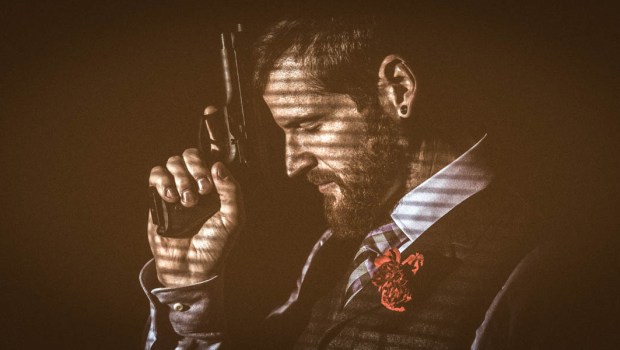 MAN PRAYING WITH GUN