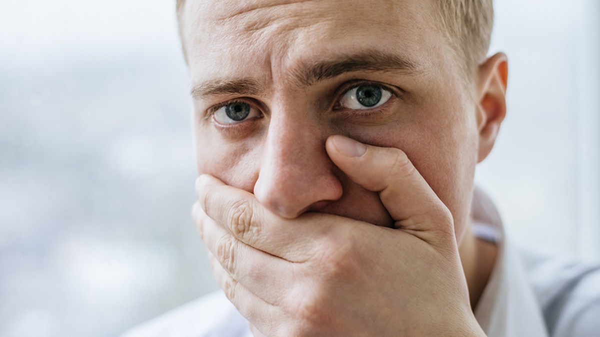 Man Covering Mouth