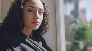 Woman Looking Out Window